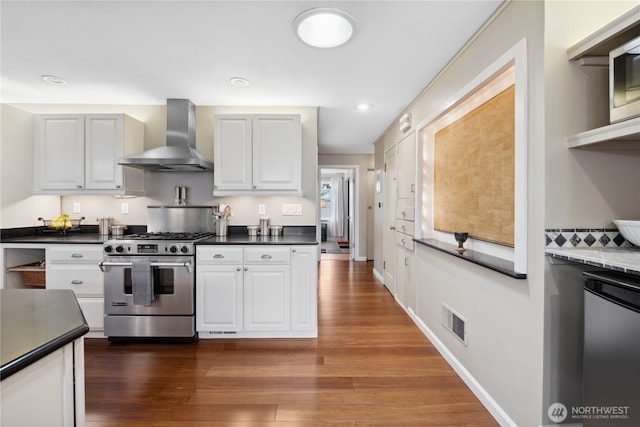 15825 10th Ave SW, Burien, WA 98166 - kitchen with stainless steel gas range oven, wall chimney exhaust hood, wood finished floors, dark countertops, and recessed lighting