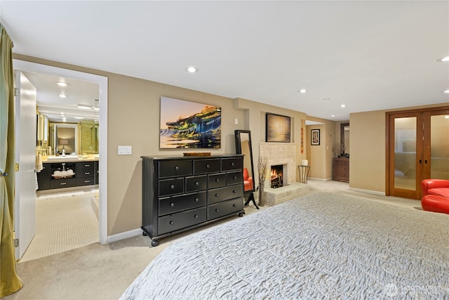 15825 10th Ave SW, Burien, WA 98166 - bedroom with light colored carpet, a brick fireplace, baseboards, recessed lighting, and ensuite bathroom