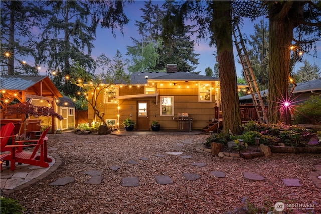 15825 10th Ave SW, Burien, WA 98166 - back of property at dusk featuring a patio and a chimney