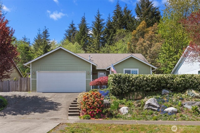 ranch-style home with a garage, fence, and concrete driveway