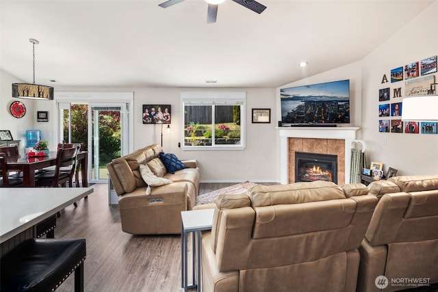 living room with a tiled fireplace, a ceiling fan, wood finished floors, and recessed lighting