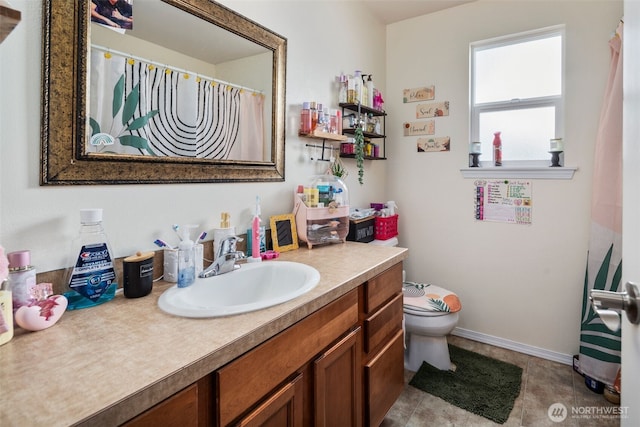 full bath with vanity, baseboards, and toilet