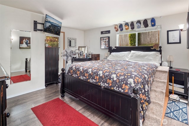 bedroom featuring baseboards and wood finished floors