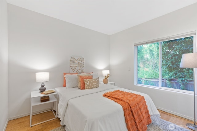 bedroom with wood finished floors and baseboards