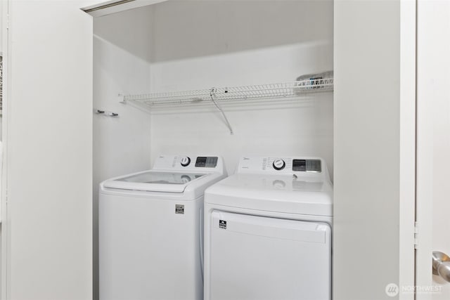 washroom featuring washer and clothes dryer