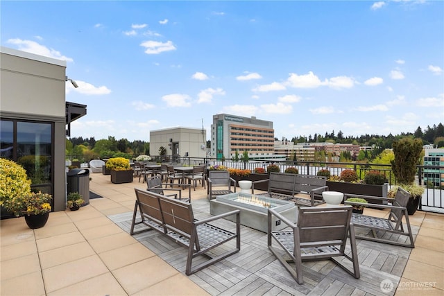 view of patio featuring an outdoor living space with a fire pit