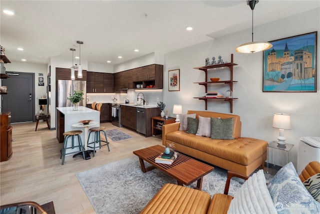 living room with recessed lighting and light wood finished floors