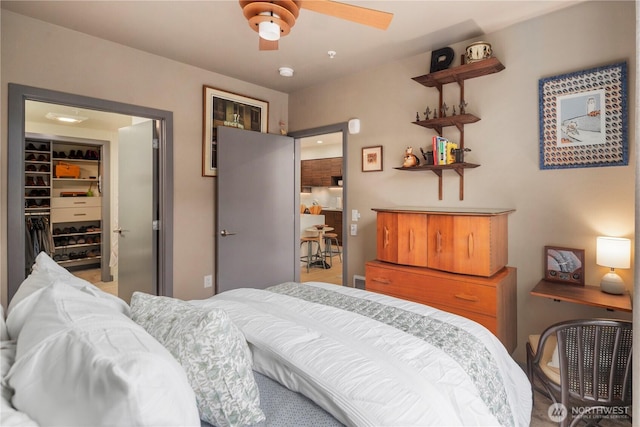 bedroom featuring a ceiling fan, a spacious closet, and a closet