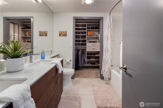 full bath with a sink, shower / bath combo, double vanity, toilet, and tile patterned floors