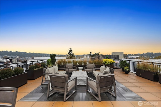 patio terrace at dusk featuring outdoor lounge area