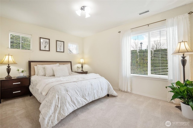 bedroom featuring baseboards, carpet flooring, and visible vents