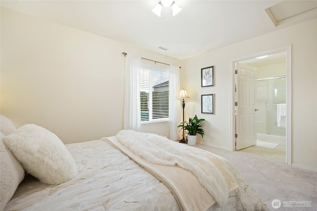 carpeted bedroom featuring connected bathroom, baseboards, and visible vents