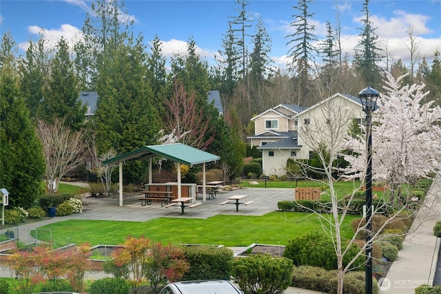 surrounding community with a patio area and a yard