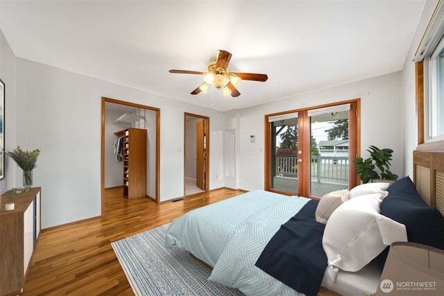 bedroom featuring baseboards, access to outside, a ceiling fan, and wood finished floors