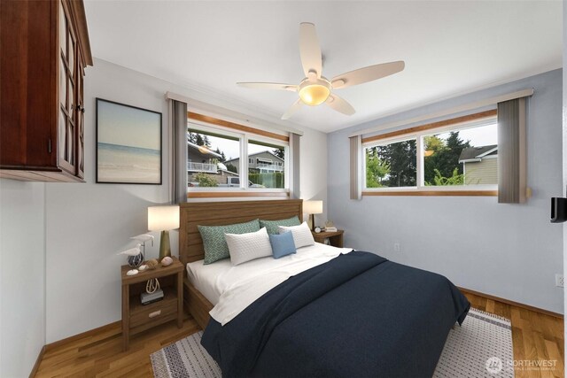 bedroom with baseboards, light wood-style flooring, and ceiling fan