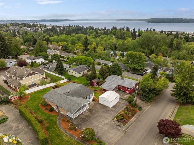 birds eye view of property with a water view and a residential view