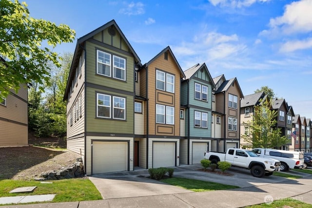 7169 27th Ave SW Unit 121, Seattle, WA 98106 - view of property with a residential view, board and batten siding, an attached garage, and driveway