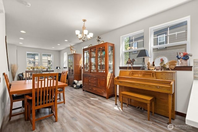dining room featuring an inviting chandelier, recessed lighting, and light wood-style flooring