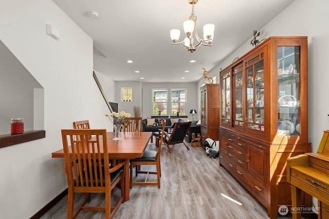 dining area featuring recessed lighting, light wood-style flooring, baseboards, and a chandelier