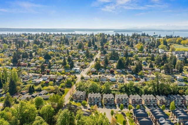 birds eye view of property with a residential view and a water and mountain view