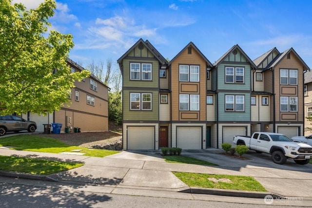 view of property with an attached garage and driveway