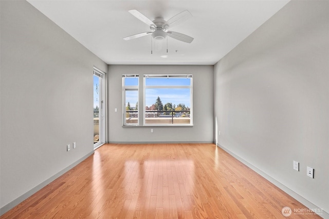 unfurnished room featuring light wood-type flooring, ceiling fan, and baseboards