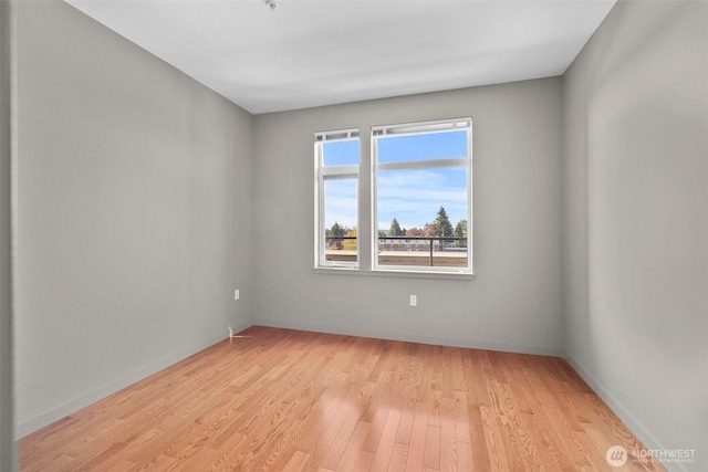 spare room with light wood finished floors and baseboards