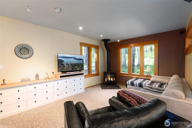 166 White Point Rd, Friday Harbor, WA 98250 - living room featuring a wood stove, carpet flooring, and healthy amount of natural light