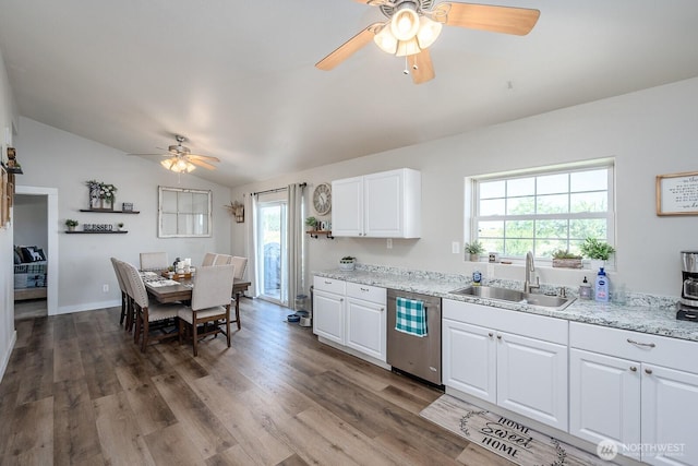 kitchen with plenty of natural light, a ceiling fan, dishwasher, a sink, and lofted ceiling