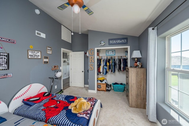 bedroom with light carpet, baseboards, lofted ceiling, visible vents, and a closet