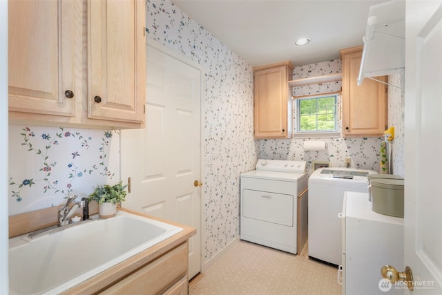 laundry area with wallpapered walls, cabinet space, separate washer and dryer, baseboards, and light flooring