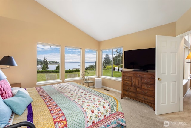 bedroom with light carpet, high vaulted ceiling, and baseboards