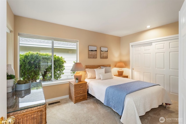 bedroom with light carpet, baseboards, multiple windows, a closet, and recessed lighting