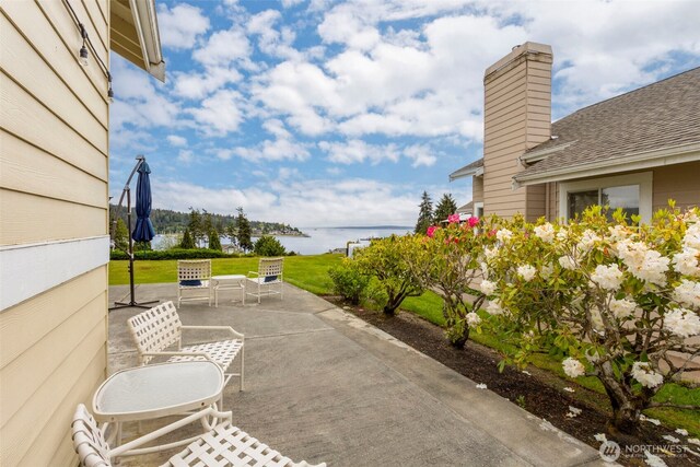 view of patio featuring a water view