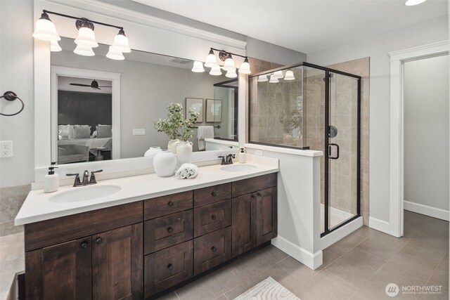 full bath with double vanity, a sink, ensuite bath, and a stall shower