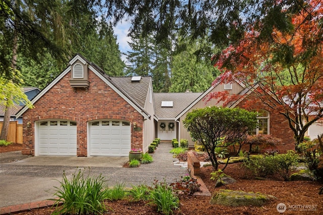 view of front of property with an attached garage, driveway, and brick siding