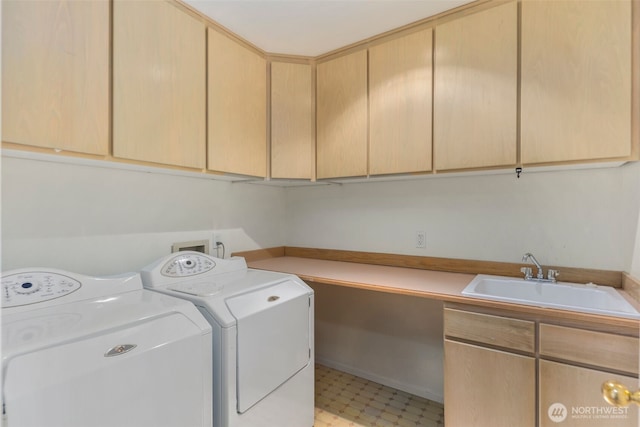 clothes washing area featuring cabinet space, separate washer and dryer, a sink, and light floors
