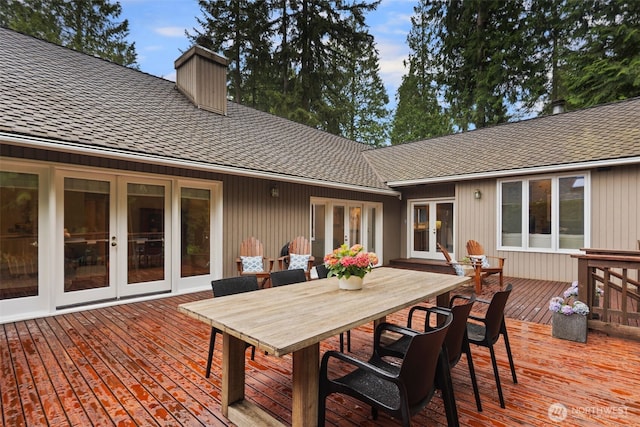 wooden terrace with french doors and outdoor dining space