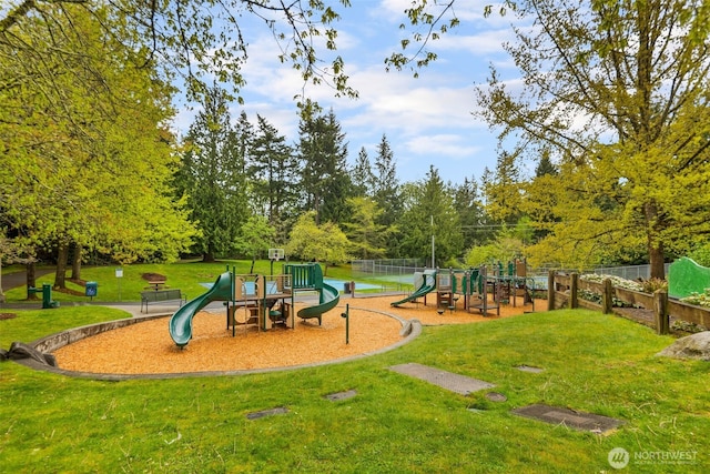 communal playground with fence and a yard
