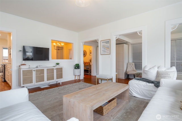 living area featuring a notable chandelier and wood finished floors