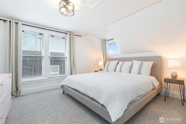 bedroom featuring baseboards, multiple windows, and carpet flooring