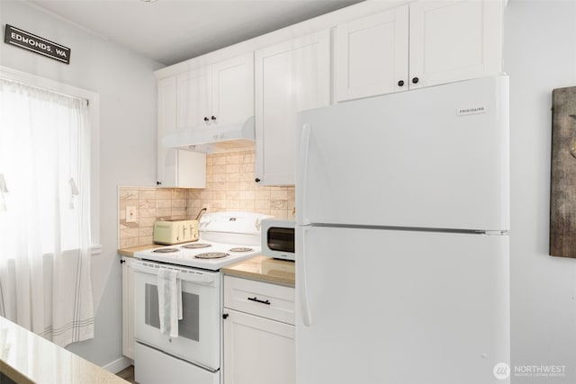kitchen with white cabinets, white appliances, light countertops, decorative backsplash, and under cabinet range hood