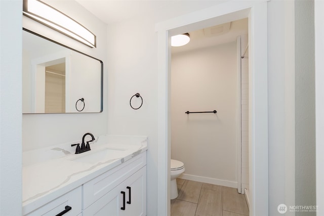full bath with vanity, tile patterned flooring, baseboards, and toilet