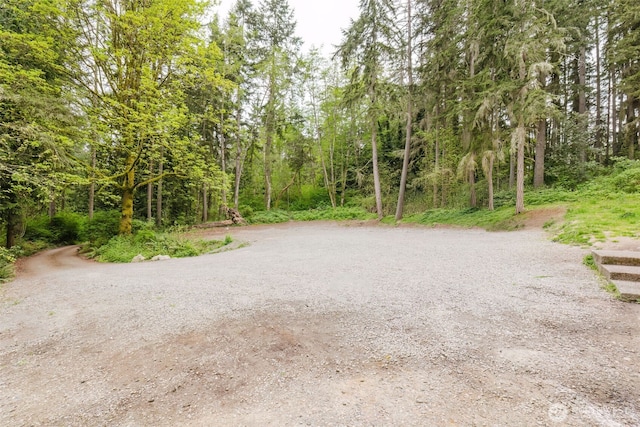 surrounding community with a wooded view