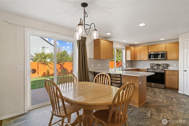 dining area with recessed lighting, a textured ceiling, and baseboards