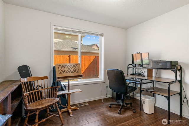 office space featuring baseboards, wood finished floors, and visible vents