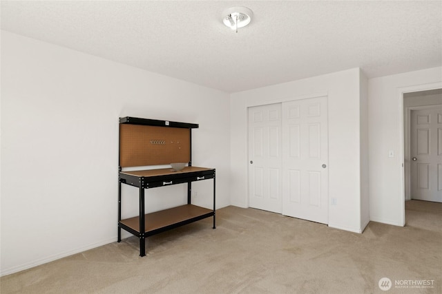 bedroom featuring a closet, baseboards, and carpet flooring