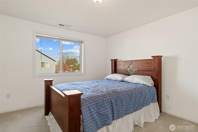 bedroom featuring visible vents, baseboards, and light colored carpet
