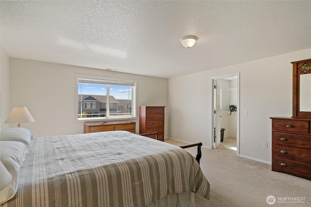 bedroom with baseboards, visible vents, a textured ceiling, and light colored carpet