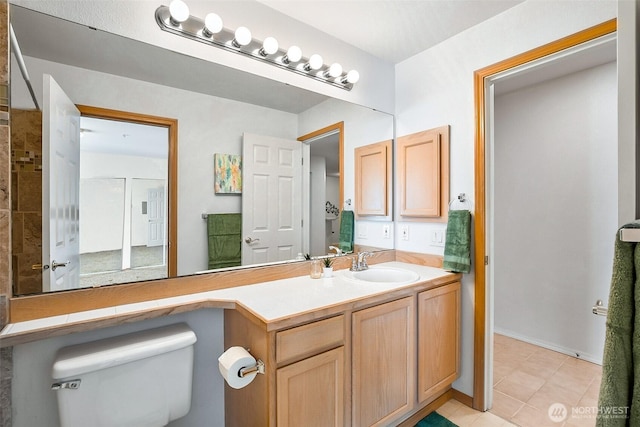 bathroom featuring toilet, tile patterned floors, and vanity